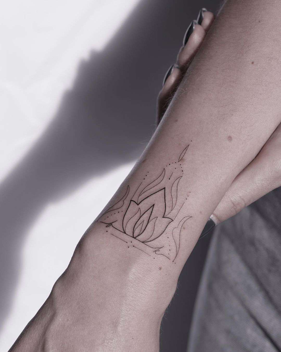 Flor de loto tatuaje minimalista